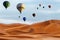 Beautiful Colorful Hot Air Baloons and dramatic clouds over the sand dunes in the desert