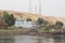 Beautiful colorful houses on an island in Aswan in the middle of greenery on the Nile shore