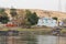 Beautiful colorful houses on an island in Aswan in the middle of greenery on the Nile shore