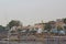 Beautiful colorful houses on an island in Aswan in the middle of greenery on the Nile shore with boats in the water