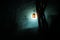 Beautiful colorful illuminated lamp in the garden in misty night. Retro style lantern at night outdoor