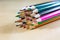 Beautiful and colorful pencil crayons. Bright wooden table.