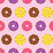 Beautiful colorful rainbow cute donuts circle realistic many taste pattern on pink