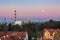 Beautiful colorful sky and moon, urban landscape, factory and houses. Elblag in Poland