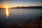 Beautiful colorful sunrise landscape. Pebble beach and costline of lake Liptovska Mara, Slovakia