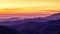 Beautiful colorful sunrise with white fog covered layers mountain range in early morning