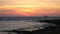 Beautiful colorful sunset on the Mediterranean sea beach. Lonely ship sail by beautiful rippling water