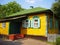 Beautiful colorful ukrainian village house exterior with red porch and green, white windows with shutters