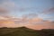 Beautiful colorful Winter sunset landscape over Latrigg Fell in Lake District with single person on hilltop admiring sunset