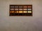 The beautiful colors of the afterglow reflecting in a wooden paneled window