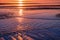 Beautiful colors of overlapping waves and the sand dunes at sunset