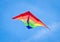 A beautiful, colourful stunt kite, in the blue sky, high up in the wind