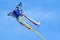 A beautiful, colourful stunt kite, in the blue sky, high up in the wind in form of a butterfly