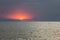 Beautiful colourful sunset evening over the Black sea with big dark waves, Kinburn Foreland shore, Ukraine