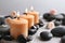 Beautiful composition with candles and spa stones on table