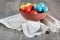 Beautiful composition of multicoloured Easter eggs in a clay bowl