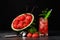 A beautiful composition of watermelon products on a black background. Red watermelon scoops and sweet berry beverage