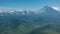 Beautiful conical volcanoes with snow-covered slopes against the blue sky