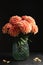 Beautiful coral dahlia flowers in vase on table against black background