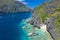 Beautiful coral reef, boats and a clear ocean on Matinloc Island, Bacuit Archipelago, El Nido, Palawan, Philippines