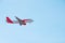 A beautiful corporate plane flies in the sky, a clear day in Portugal, tourist transport and mail delivery. bottom view