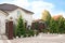 Beautiful cottage exterior with elegant fence and many green plants