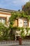 Beautiful cottage overgrown with ivy on a city street