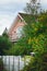 Beautiful country house surrounded by green trees. Vertical photo