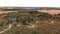 Beautiful countryside with a small river and autumn trees. Aerial landscape.