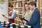 Beautiful couple choosing wine in supermarket