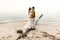 A beautiful couple is embracing on the sea background. Moment before the kiss. Romantic date on the beach. Wedding