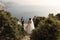 Beautiful couple. gorgeous bride in wedding dress posing with elegant groom on sea cost