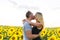 Beautiful couple having fun in sunflowers fields