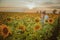 Beautiful couple having fun in sunflowers fields