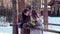 Beautiful couple hipsters with flowers on a wooden bridge in the country