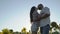 Beautiful couple kisses in sunflowers field