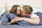 Beautiful couple kissing on bed in bedroom in the morning, romance and love in relationship