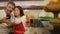 Beautiful couple lifestyle - young happy and mixed ethnicity couple in love cooking together at home kitchen the Asian woman in