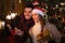 Beautiful couple lighting sparklers for christmas in front of a