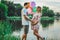 Beautiful couple in love on the background of the lake in the park in summertime closeup