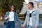 Beautiful couple in love in denim clothes holding hands and looking at each other. Street walking