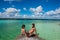 Beautiful couple in love looking at tranquil Bacalar lake. Riviera Maya, Mexico. Tropical travel.