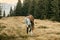 A beautiful couple in love are walking with the cat and smiling cheerfully in nature