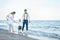 Beautiful couple in love walking on the ocean. Young family with child walking on the seashore