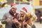 Beautiful couple with Santa hats holding sprinklers in the city