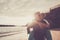 Beautiful couple of seniors at the beach having fun together and playing - mature man carry his wife woman with love and forever