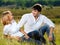 Beautiful couple sitting in meadow