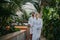 Beautiful couple standing by hot tub, wearing bathrobes, enjoying romantic wellness weekend in spa. Concept of
