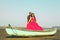 Beautiful couple standing on rowboat at beach against sky
