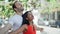 Beautiful couple standing together with arms open smiling at street